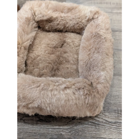 Cozy beige faux fur sheepskin pet bed with plush highland sheepskin design