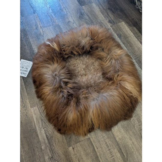 Cozy brown faux fur sheepskin pet bed with soft circular design