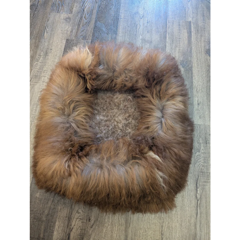 Cozy faux fur sheepskin pet bed in warm brown tan tones