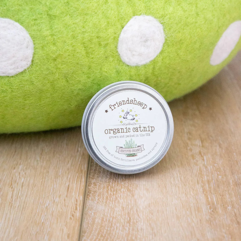 A round silver-topped tin of friendsheep organic catnip with a white label for eco kitty caves like green mushroom cat cave