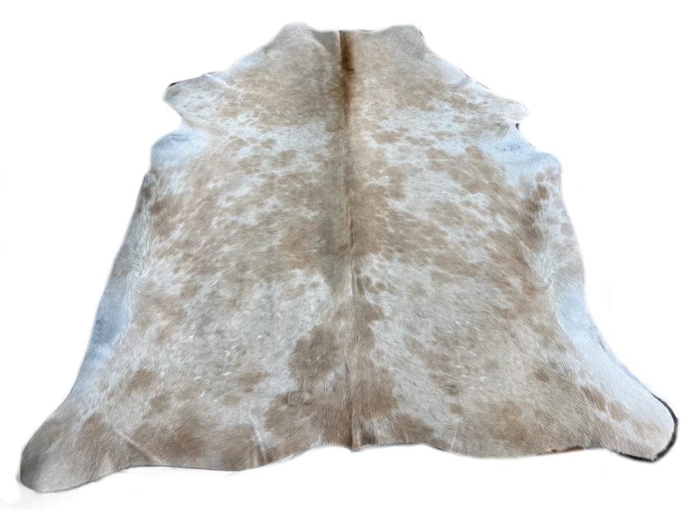 A large cowhide rug flashybeige 835 with natural tan and white colors and unique characteristics perfect for beautiful rugs
