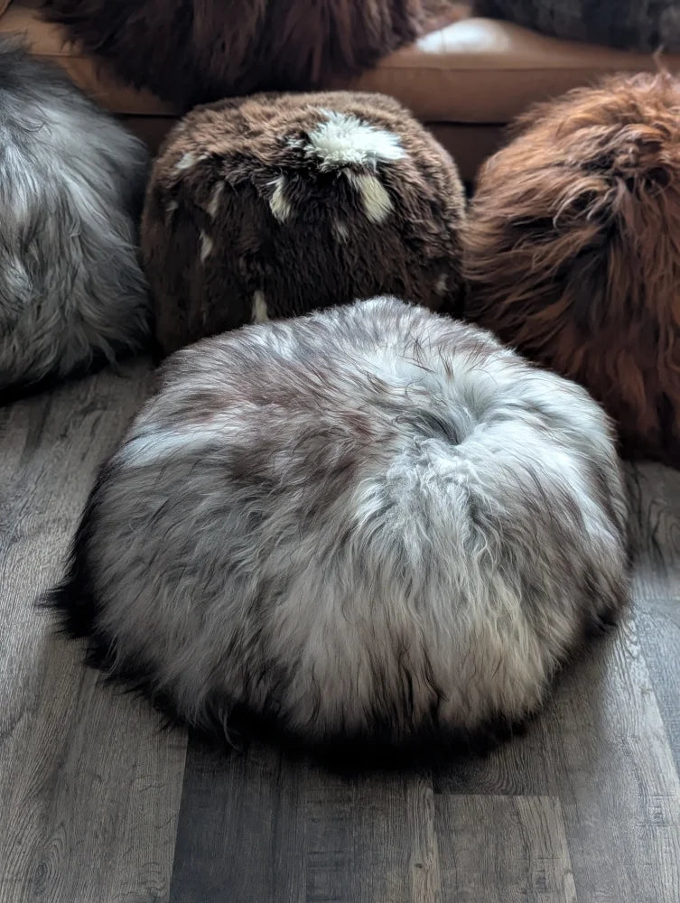 Plush gray Icelandic sheepskin floor pouf with white accents