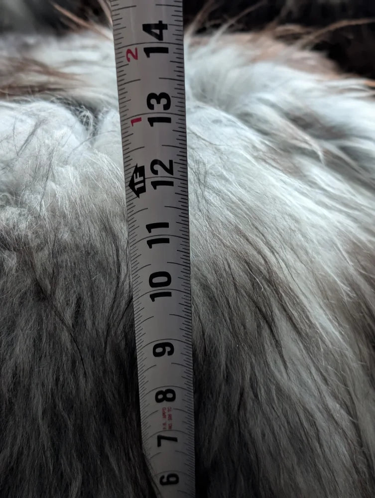 Soft grey Icelandic sheepskin floor pouf with fluffy faux fur texture