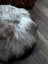 Fluffy grey Icelandic sheepskin floor pouf, soft round pouf