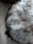 Fluffy gray white Icelandic sheepskin floor pouf rug