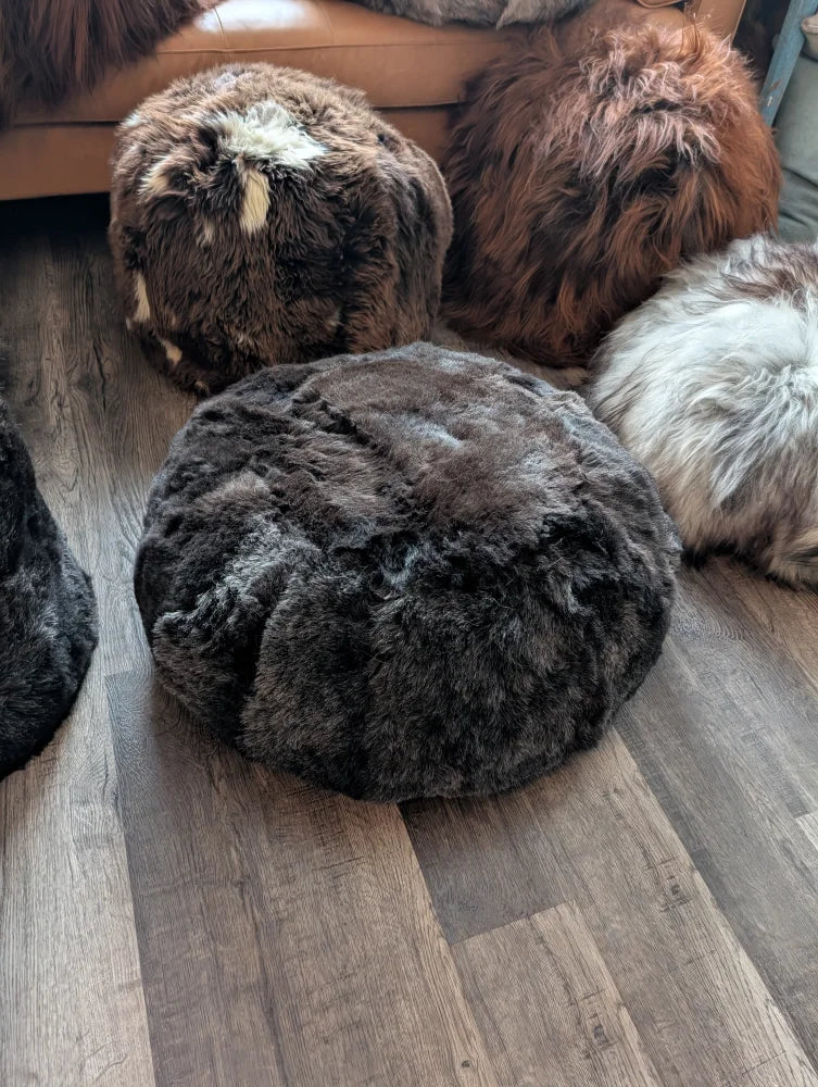 Dark gray fluffy Icelandic sheepskin floor pouf in wolf shorn style