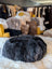 Dark gray Icelandic sheepskin floor pouf with plush wolf fur