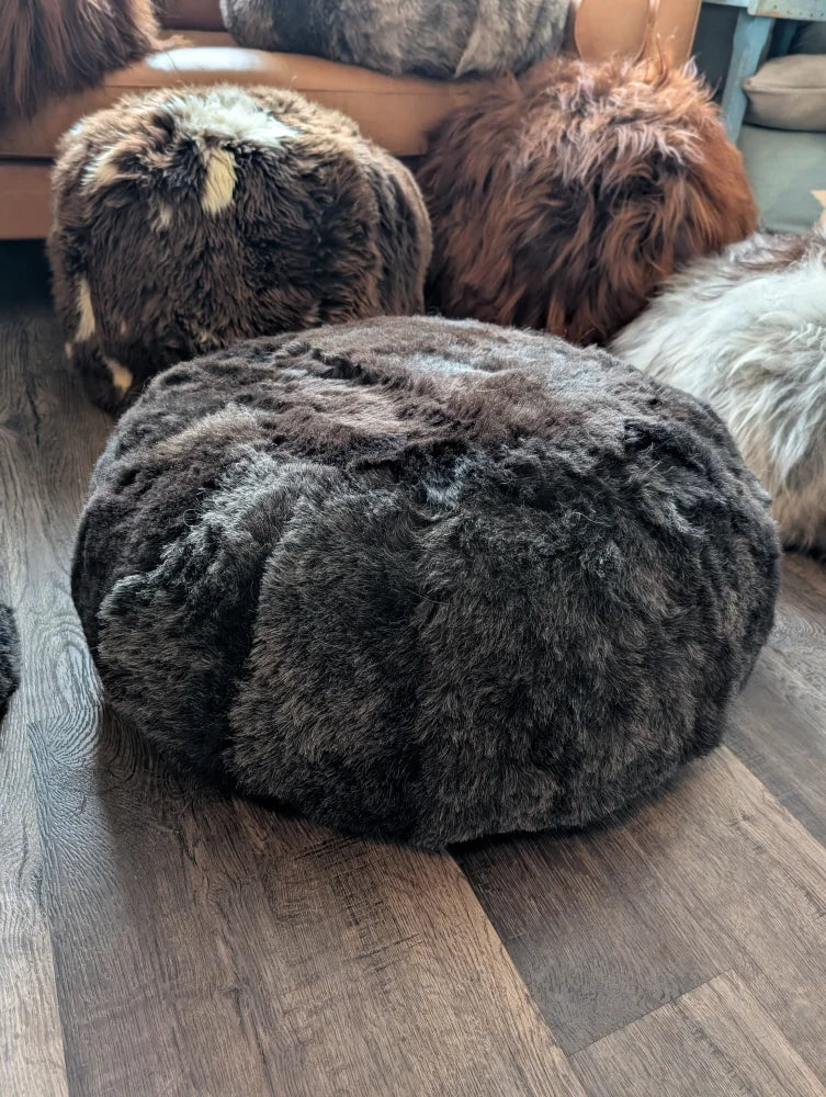 Dark gray Icelandic sheepskin floor pouf with plush wolf shorn fur