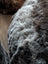 Plush curly-furred Icelandic sheepskin floor pouf in wolf gray