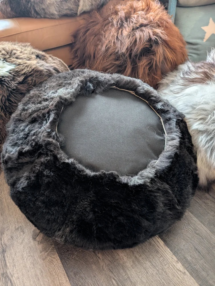Black Icelandic sheepskin floor pouf with faux fur top