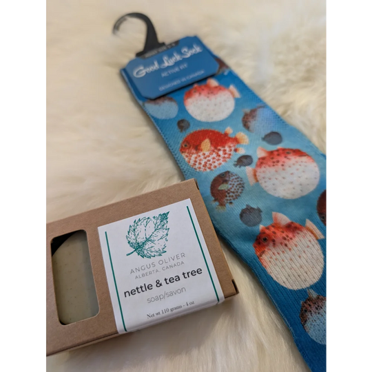 Blue sock with orange and white pufferfish pattern hanging on black hanger free with orders over 160 by angus oliver canada