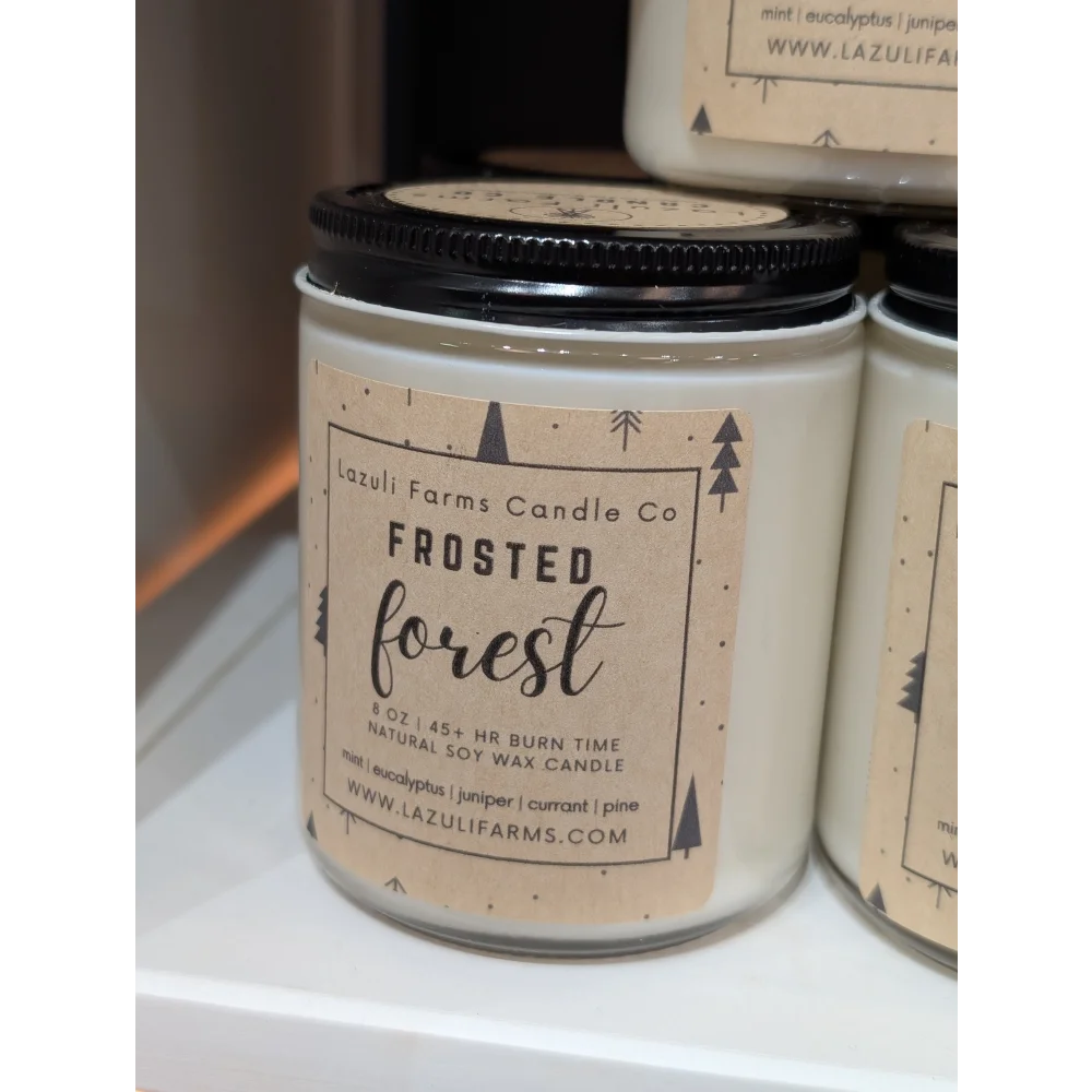 Frosted forest candle in white jar with black lid from Lazuli Farms Candle Co