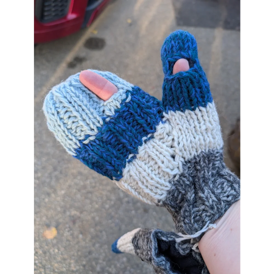 Hand wearing blue, white, gray Zealand Wool Collingwood Texting Mittens with clever flip-back thumb