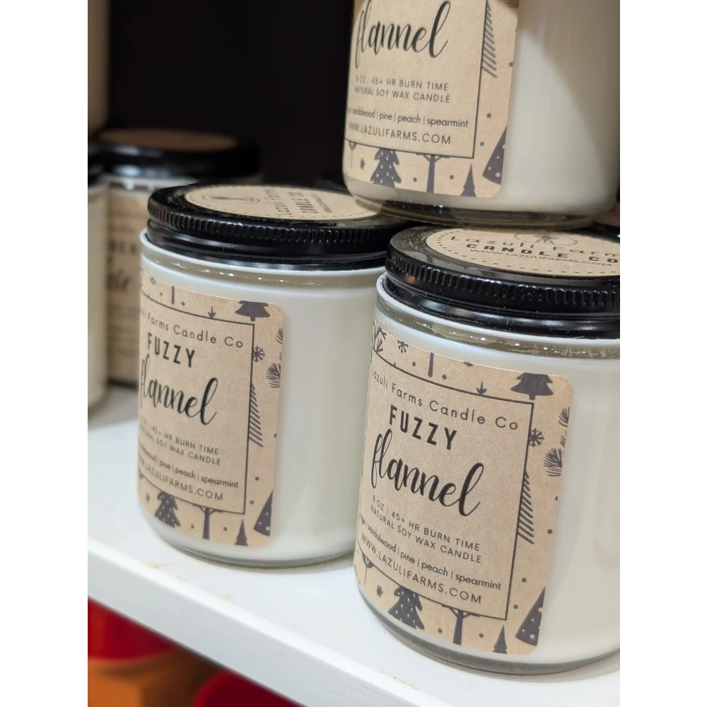 Fuzzy flannel candle in jar with pine tree label on white background