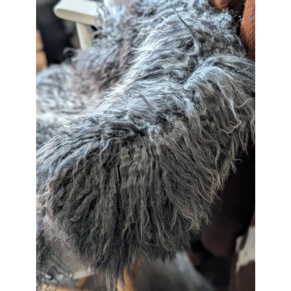 Gray fluffy dog tail on 52x31in Gotland sheepskin from Oliver Luxury Sheepskins