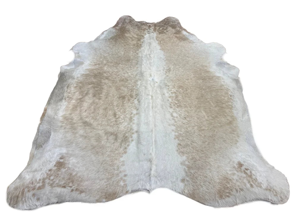 Gorgeous beige extra large cowhide rug with unique characteristics featuring creamy white and light beige rustic charm spots