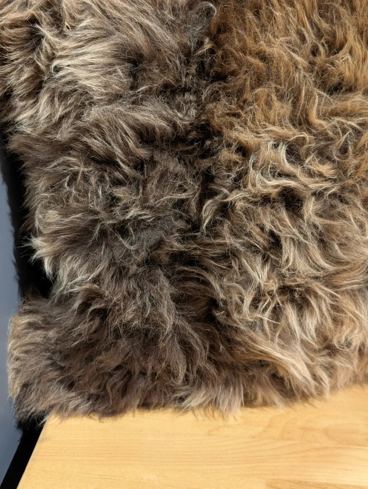 Gorgeous british sheepskin cushion with a plush curly brown rug front and unbleached cotton canvas backing