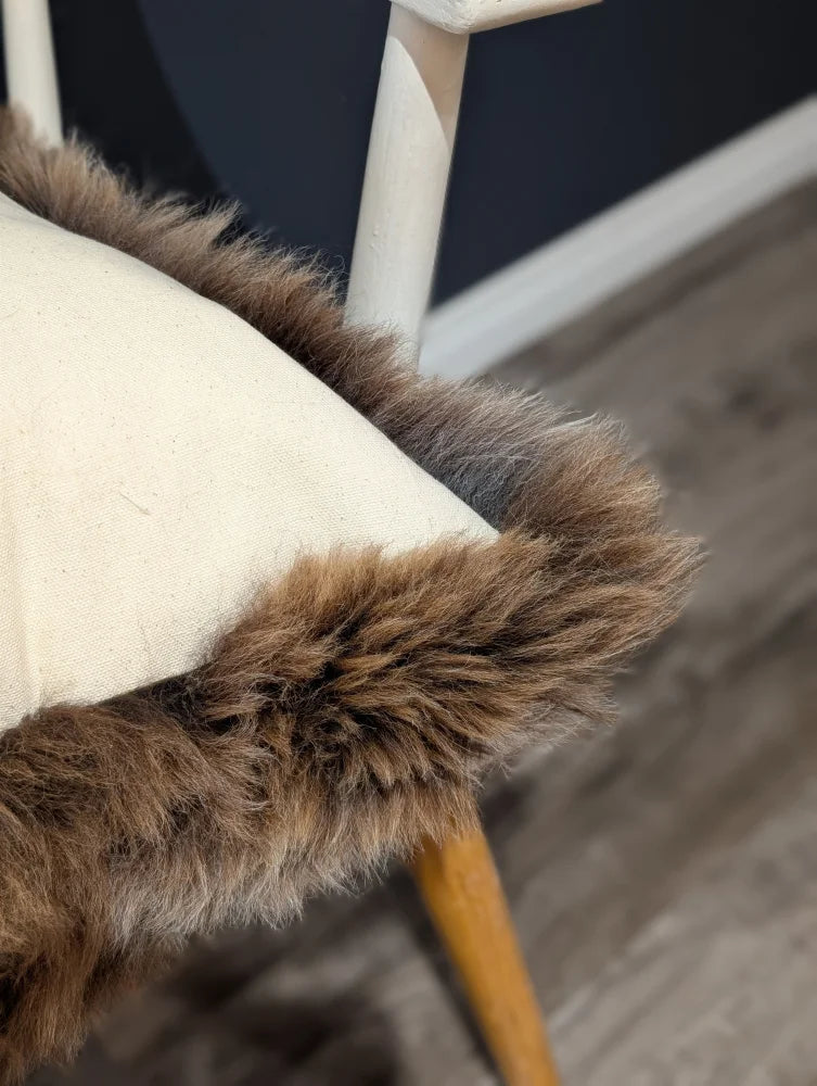 Gorgeous british sheepskin cushion with cozy brown faux fur trim on cream unbleached cotton canvas seat
