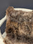Gorgeous british sheepskin cushion with plush shaggy brown and gray curly texture on unbleached cotton canvas