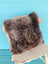 Gorgeous british sheepskin cushion with fluffy gray angus oliver sheepskin on distressed white unbleached cotton canvas chair