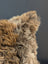 Gorgeous british sheepskin cushion with plush natural texture in brown beige tones on soft unbleached cotton canvas