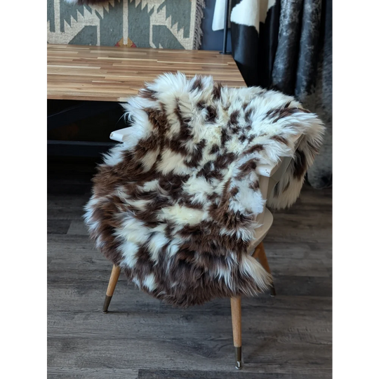 Gorgeous fluffy British sheepskin cowhide chair cover with brown white spots
