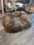 Cozy round highland sheepskin pet bed with brown tan fur