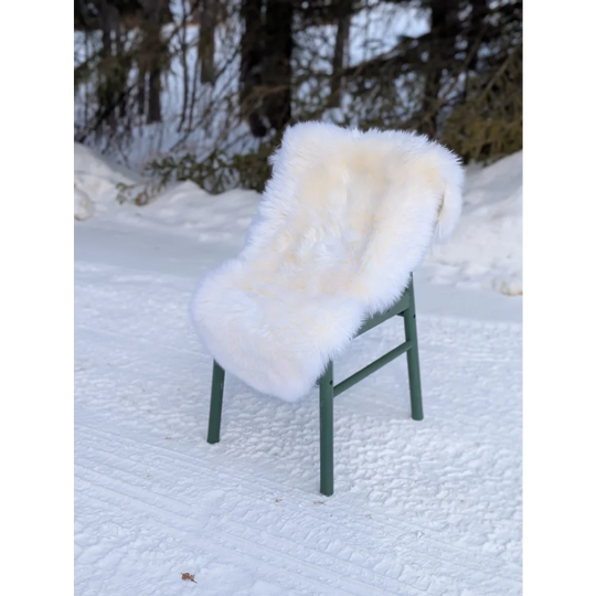 Gorgeous Merino sheepskin throw on green chair in snow, OEKO TEX certified
