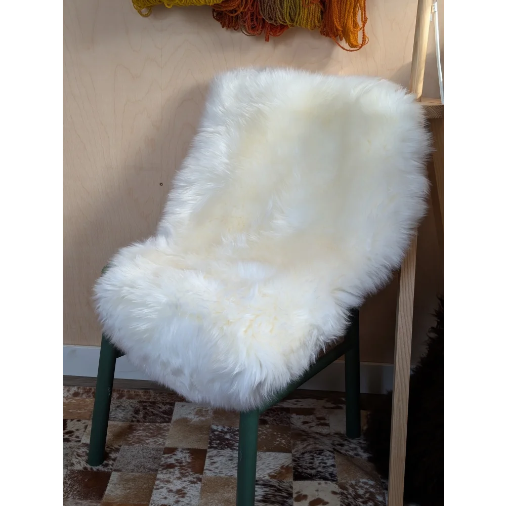 Gorgeous Merino sheepskin chair cover on green frame, OEKO TEX certified