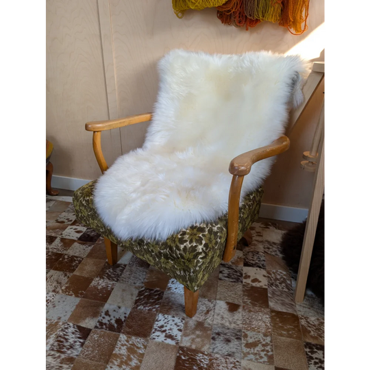 Gorgeous Merino sheepskin throw on vintage green armchair
