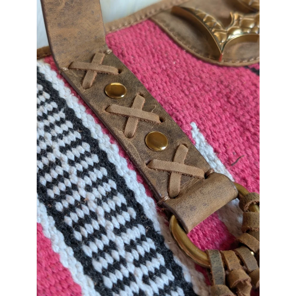 Tan leather strap with cross laced detailing and brass studs on gorgeous wool and leather bag with hand tooled leather accents
