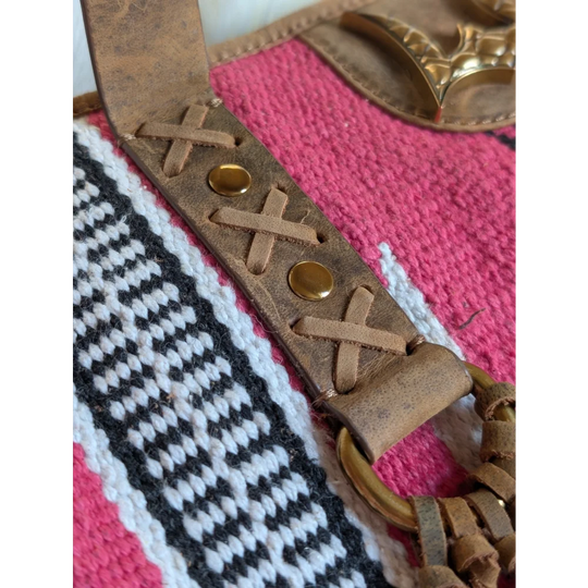 Tan leather strap with cross laced detailing and brass studs on gorgeous wool and leather bag with hand tooled leather accents