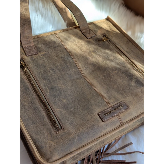 Gorgeous wool leather bag with distressed brown leather tote, fringed detailing, gold zippers, and hand-tooled leather accents