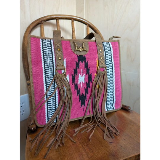 Gorgeous wool and leather bag with vibrant pink wool, hand-tooled leather accents, and black and white geometric patterns