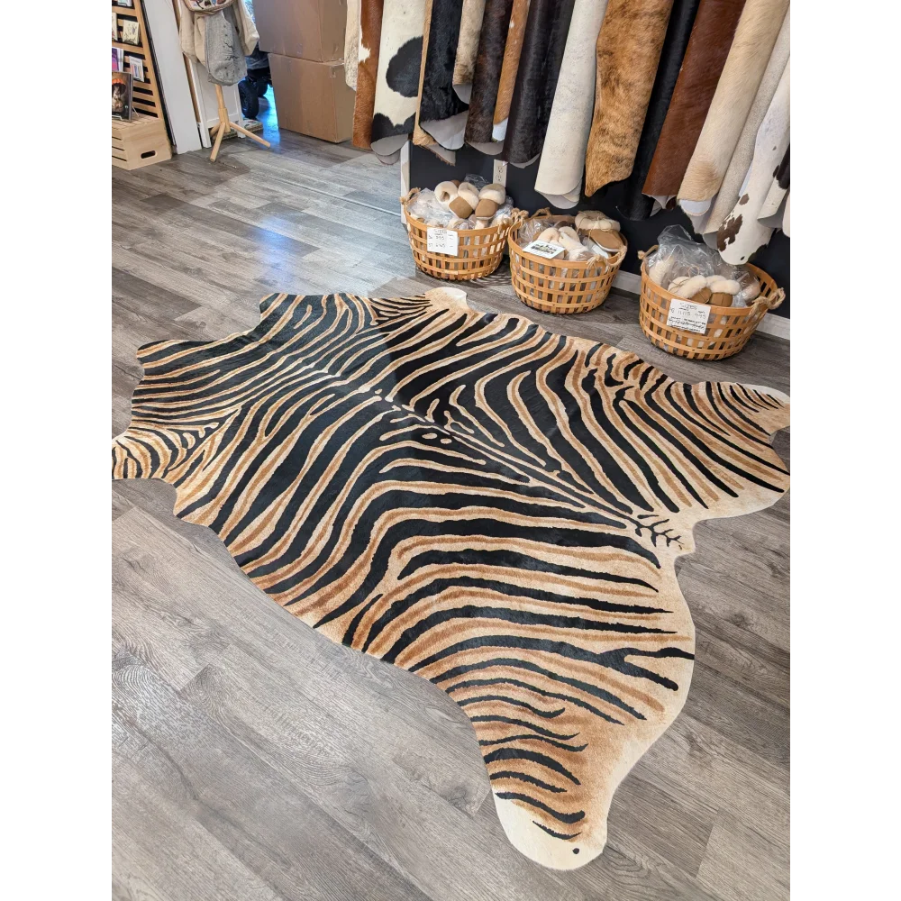 Gorgeous zebra printed large cowhide rug by angus oliver with bold black and tan stripes showing unique characteristics