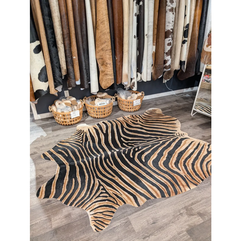 Gorgeous zebra printed large cowhide rug with bold black and tan stripes showing unique characteristics by angus oliver