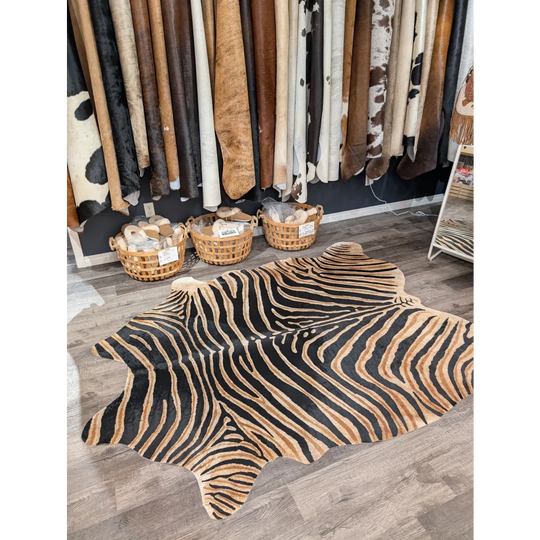 Gorgeous zebra printed large cowhide rug with bold black and tan stripes showing unique characteristics by angus oliver