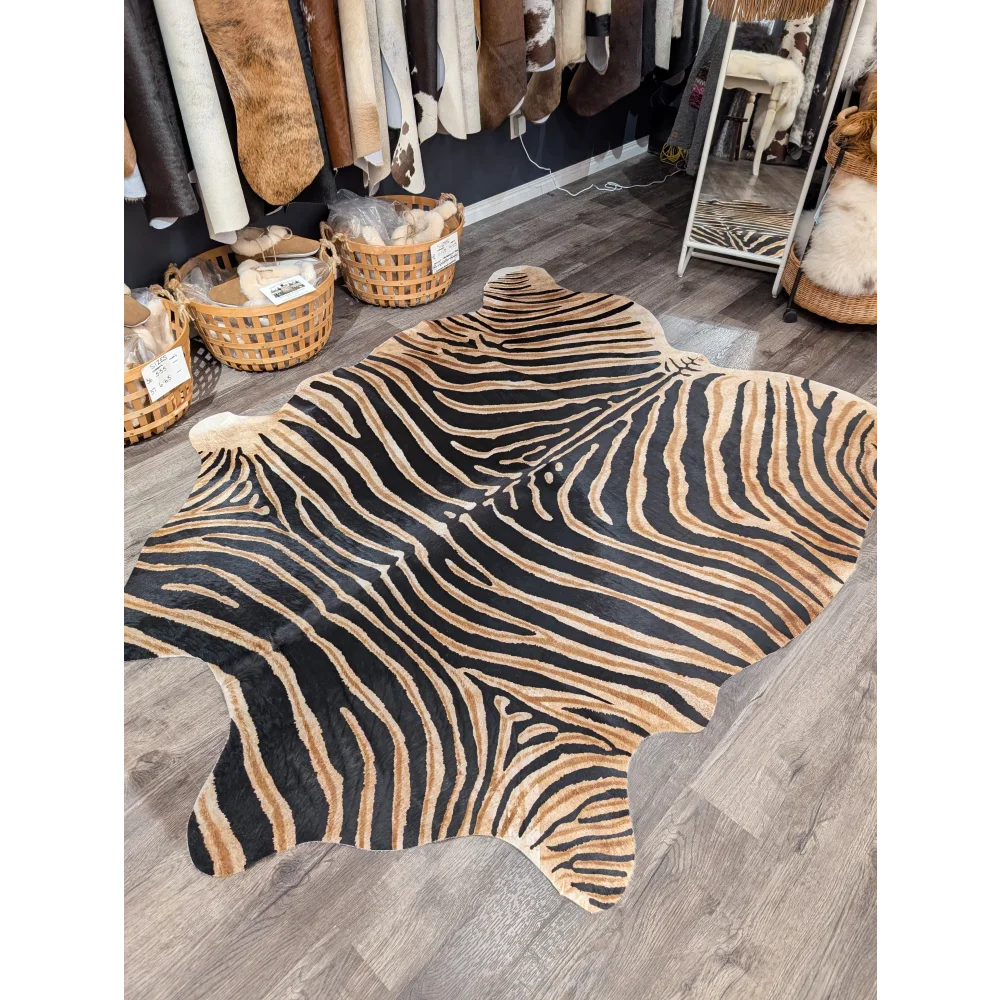 Gorgeous zebra printed large cowhide rug with bold black and tan stripes showcasing unique characteristics by angus oliver