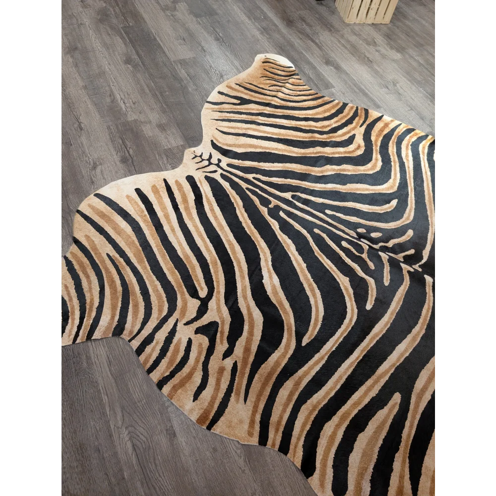 A plush angus oliver large cowhide rug with bold black and tan zebra print and unique characteristics