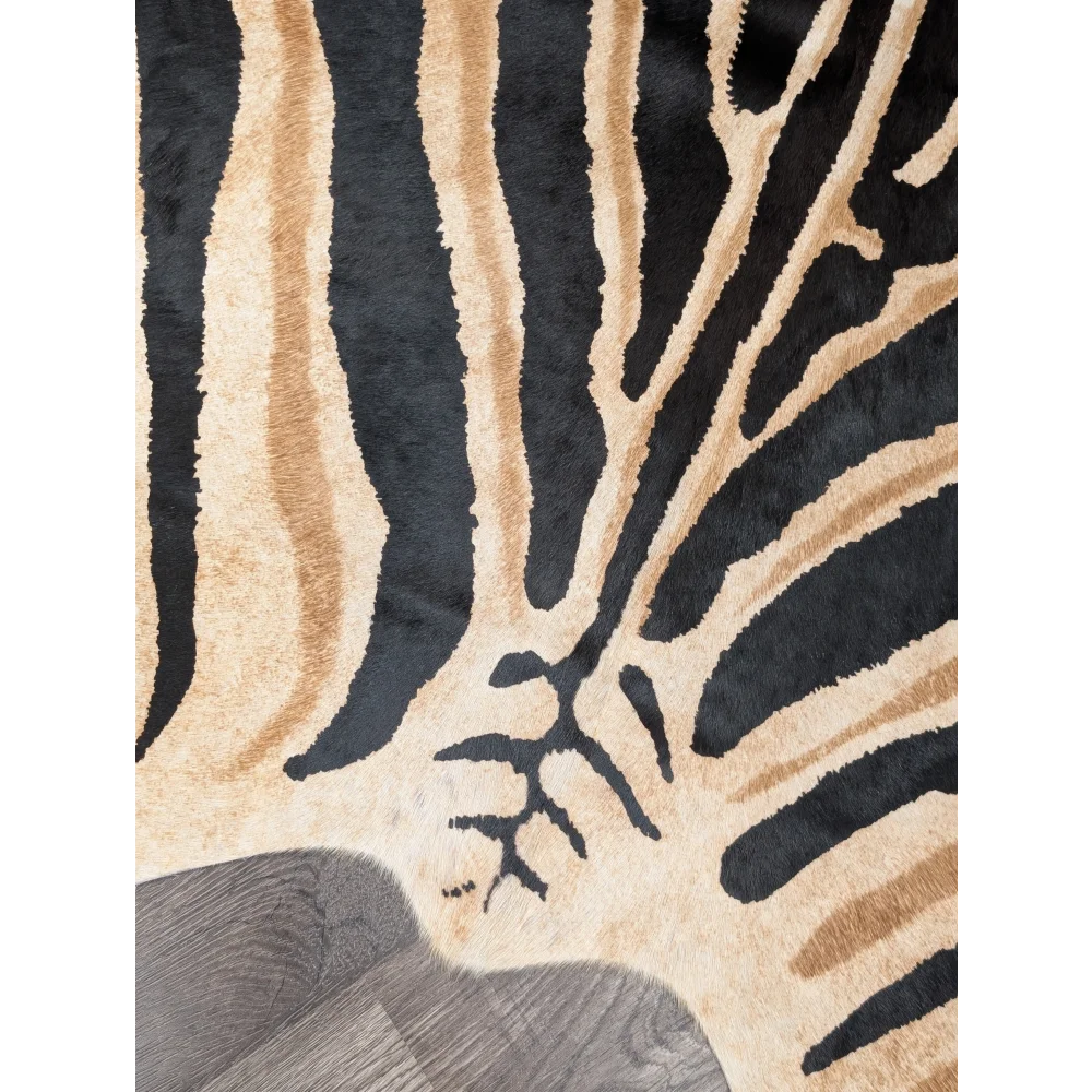 A large angus oliver plush faux leather rug with bold black and beige zebra stripes showing unique characteristics
