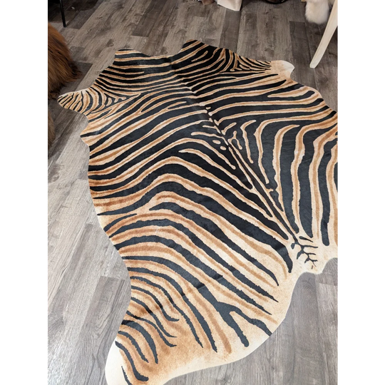 Gorgeous zebra printed cowhide rug by angus oliver with bold black and tan stripes and unique large cowhide shape
