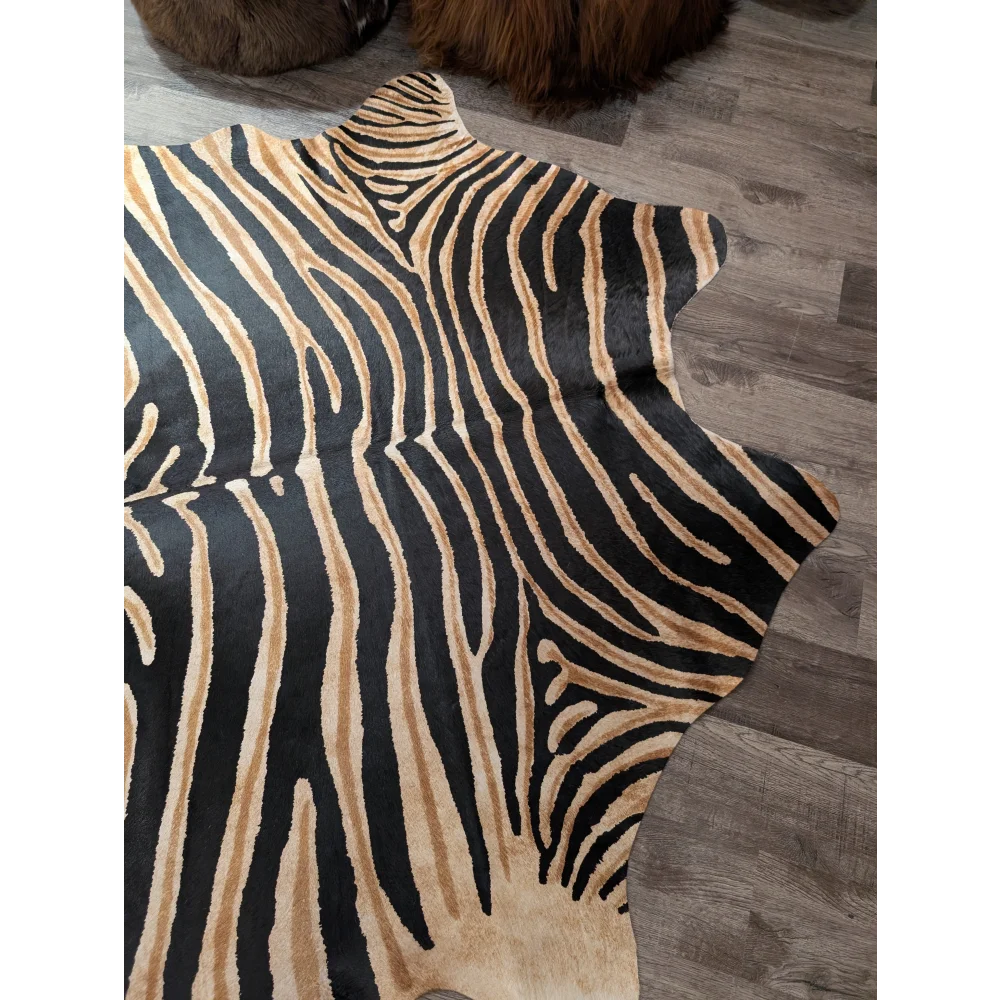 Gorgeous zebra printed large cowhide rug by angus oliver with black and tan faux fur and a natural irregular edge