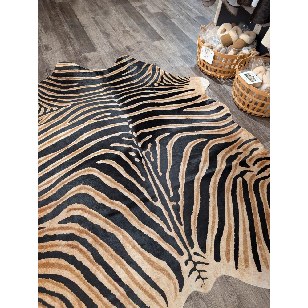 Gorgeous zebra printed large cowhide rug with black and tan zebra striped faux fur by angus oliver with unique characteristics