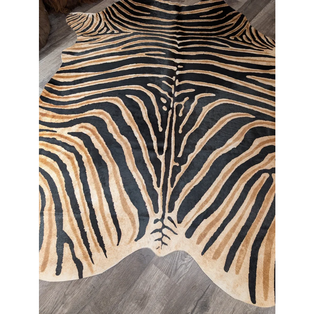Gorgeous zebra printed cowhide rug by angus oliver with bold black and tan stripes and unique large cowhide characteristics