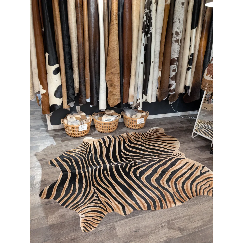 Gorgeous zebra printed large cowhide rug with bold black and tan stripes showcasing unique characteristics by angus oliver