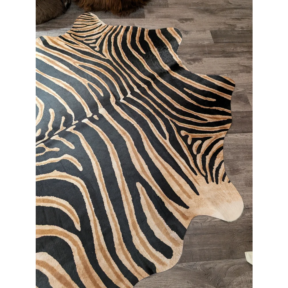 Black and tan zebra striped large cowhide rug with natural fur edge by angus oliver showing unique characteristics
