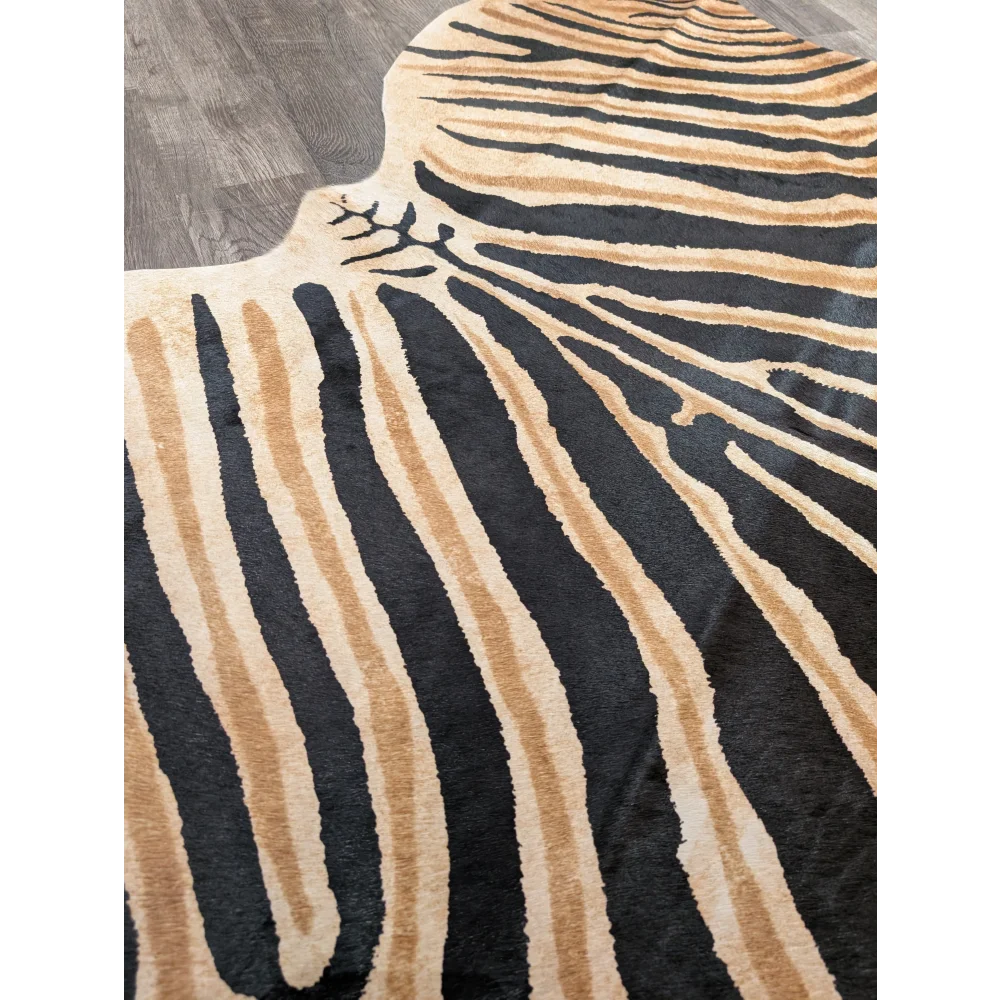 A gorgeous zebra printed cowhide rug by angus oliver with bold black and tan stripes and unique characteristics