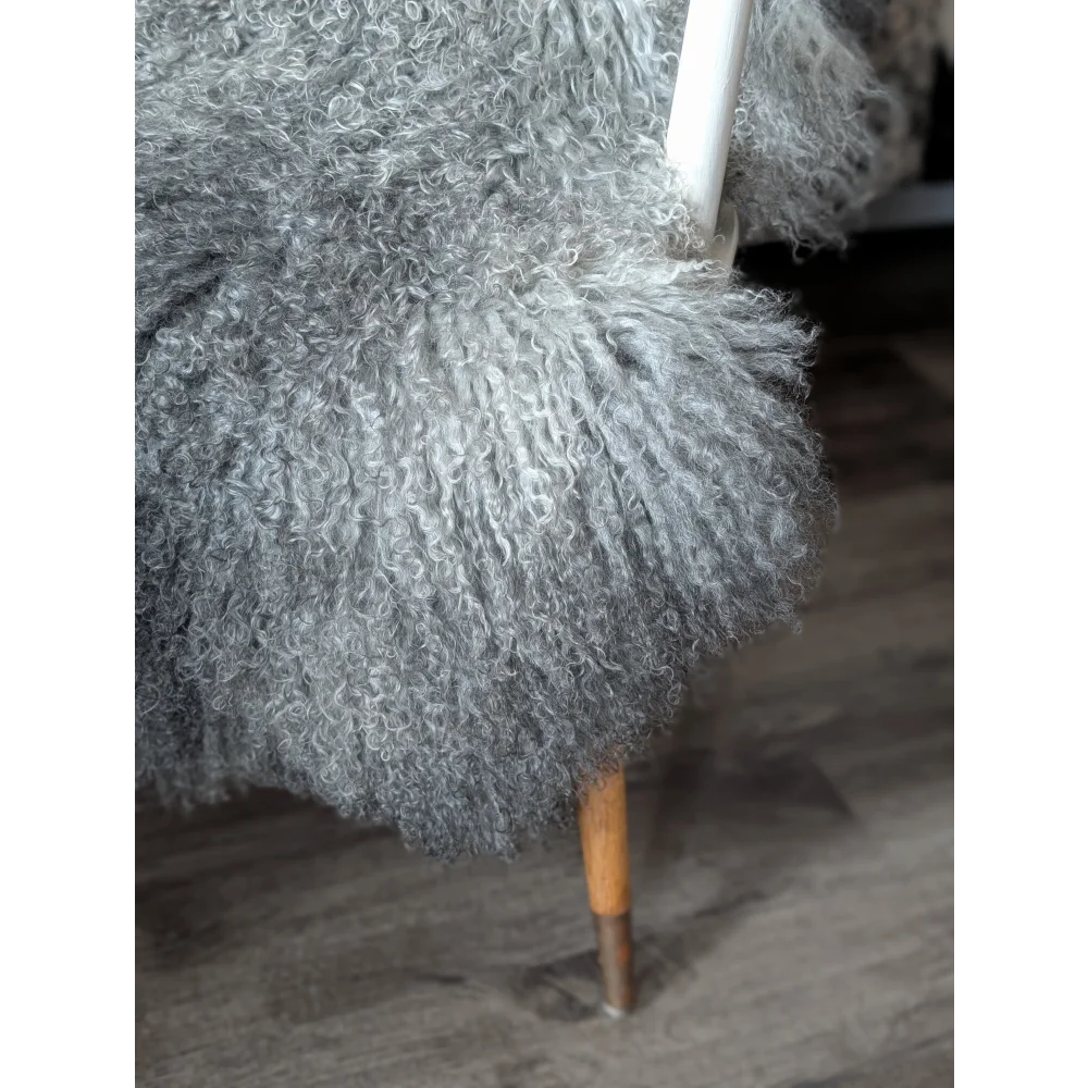 Gotland sheepskin 52x31 grey fluffy throw on white frame chair