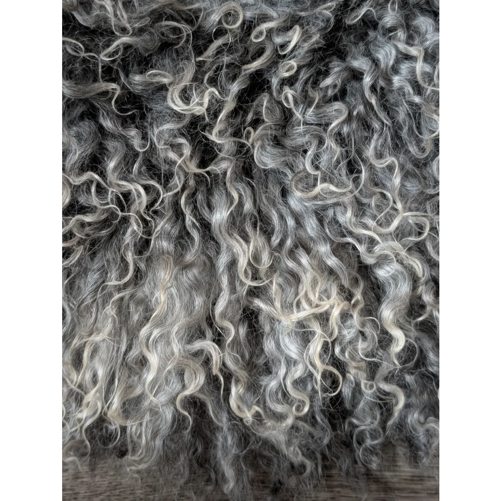 Close-up of curly gray Gotland sheepskin texture from Oliver Luxury Sheepskins