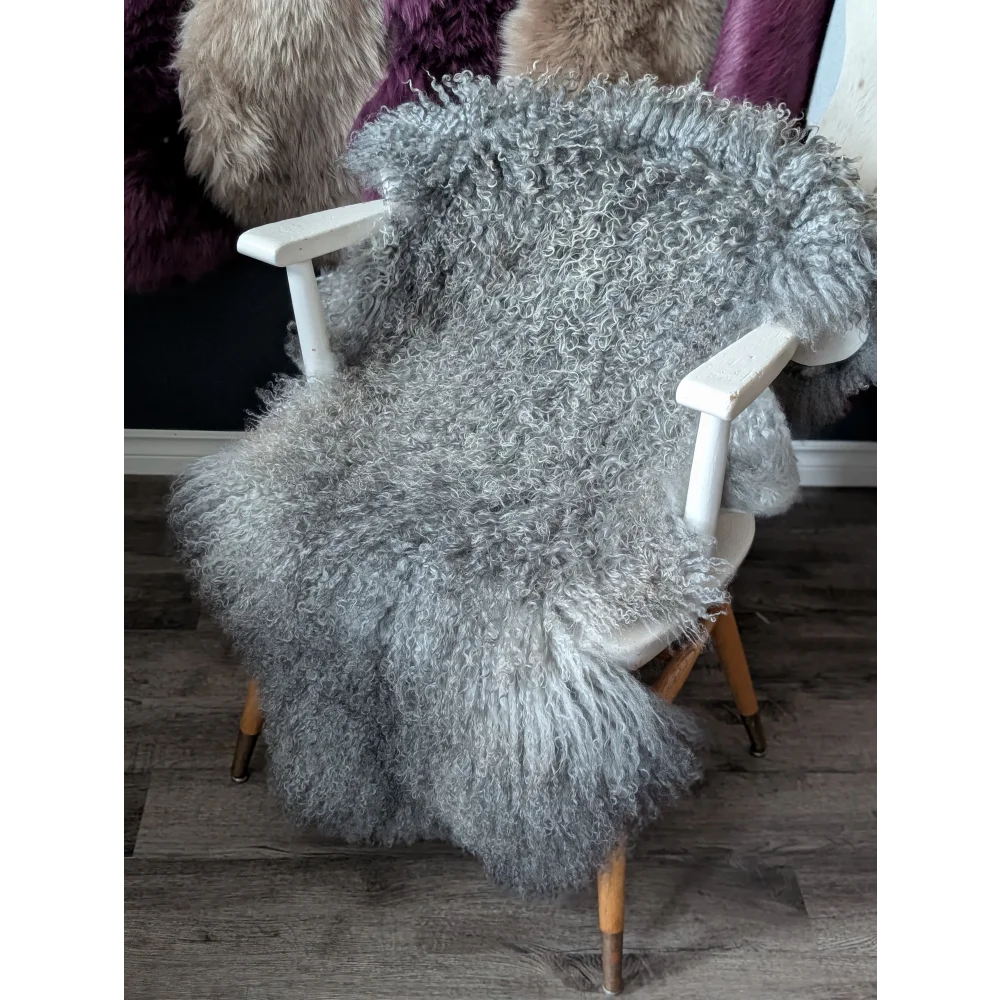 Cozy gray Gotland sheepskin throw on wooden chair from Oliver Luxury Sheepskins